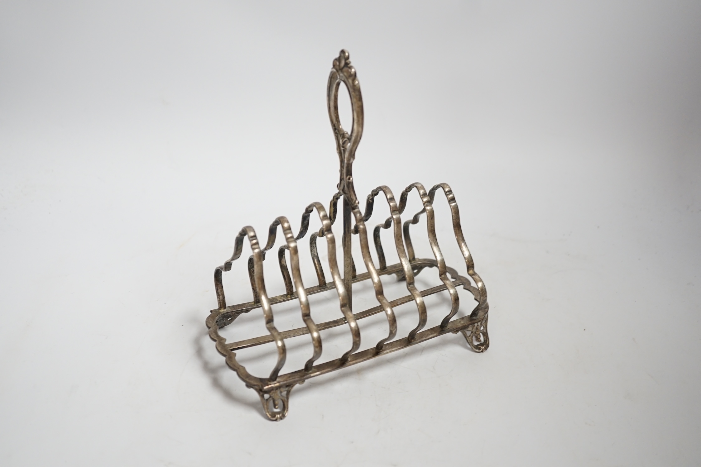 A Victorian silver seven bar toast rack, with loop handle, Henry Wilkinson & Co Ltd, Sheffield, 1874, length 18cm, 10oz.